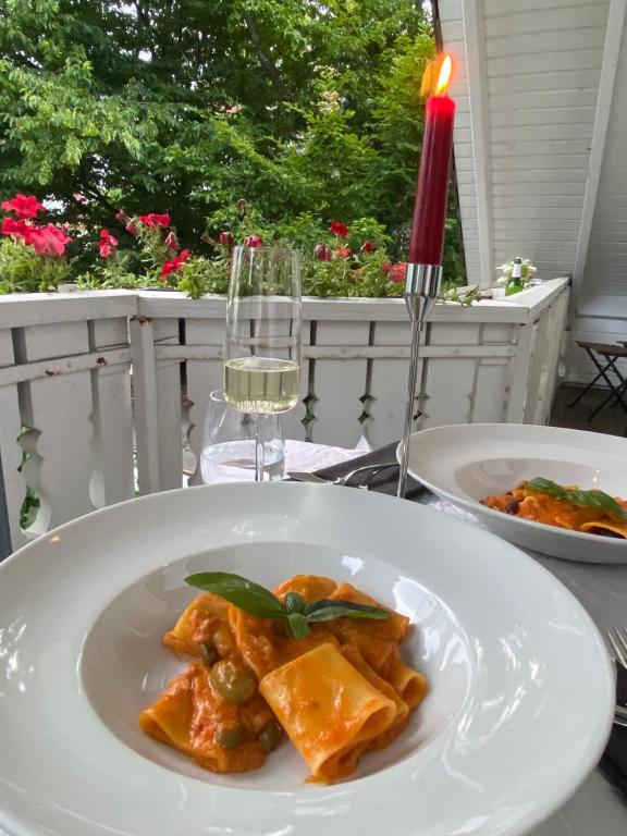 a plate of food on a table with a glass of wine at Nido Vela Appartement in Wesseling