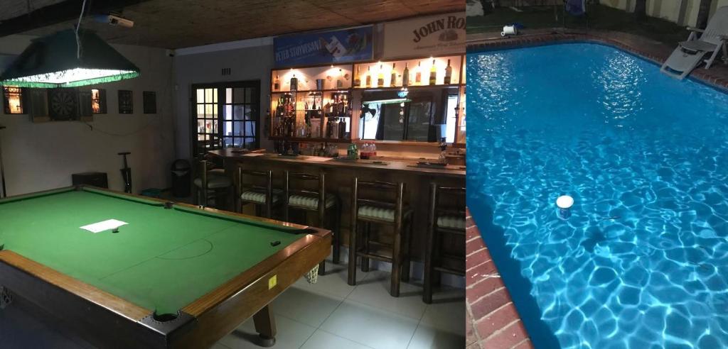a pool table next to a bar with a pool table at Robert's Place Paarl in Paarl