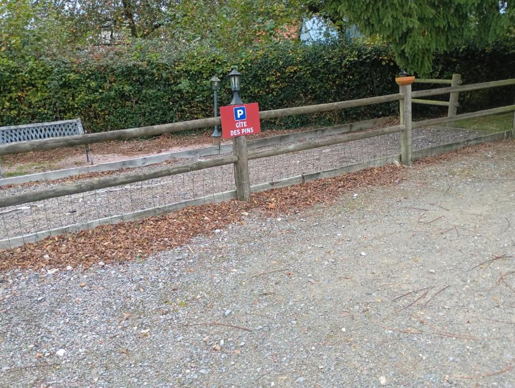 a sign on a fence with a sign on it at Gîte des pins 1 et 2 personnes in Saint-Martin-au-Bosc