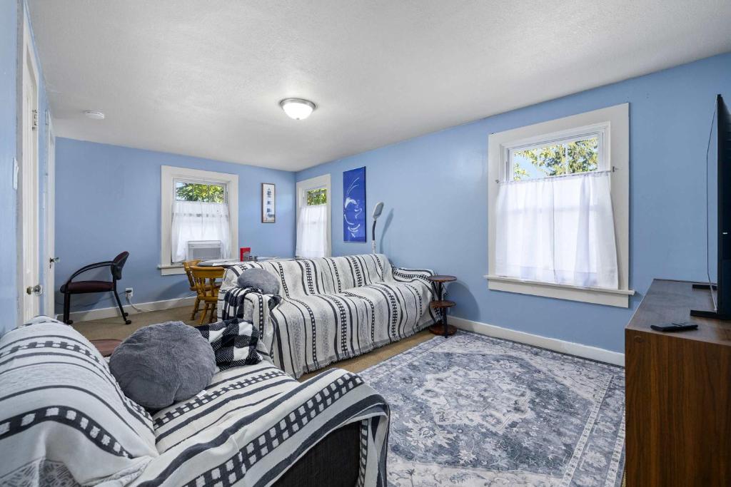 a living room with blue walls and two beds at Historic 1 Bdr across from Lakeside Park in Fort Wayne