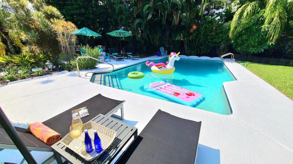 a small swimming pool with a toy in a backyard at PoshPadz Villa Oceana-Hot tub, HUGE Pool, Beach in West Palm Beach