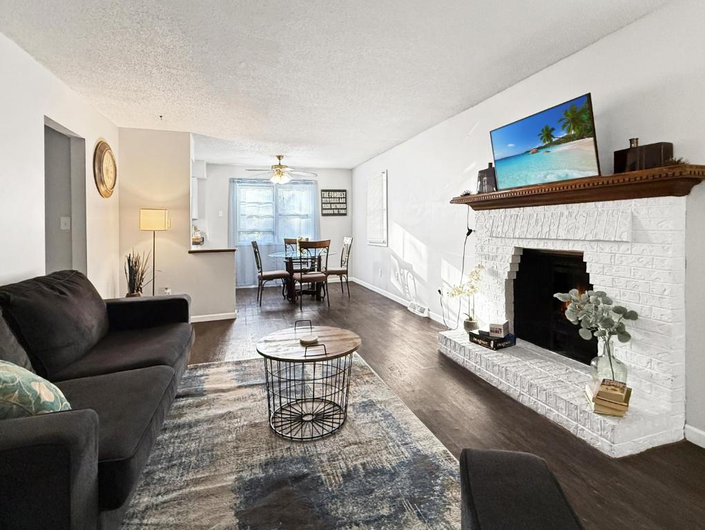a living room with a couch and a fireplace at Gorgeous Clive Charmer, Near Shops, Trails & More! in Clive