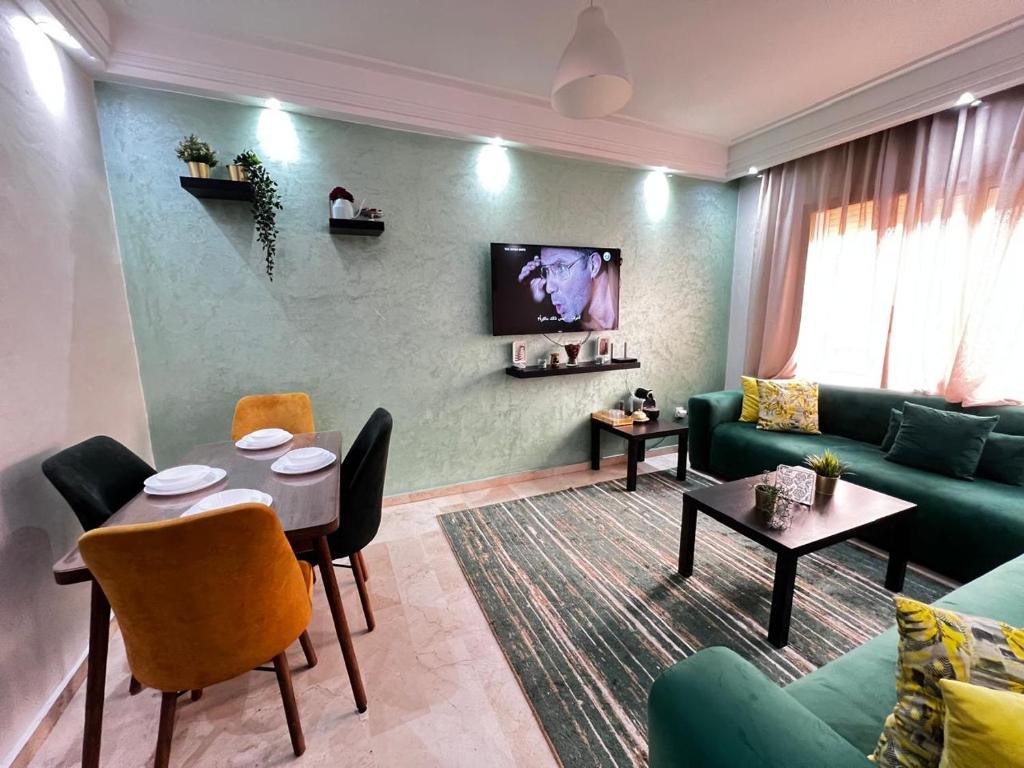 a living room with a green couch and a table at Morocco House in Casablanca