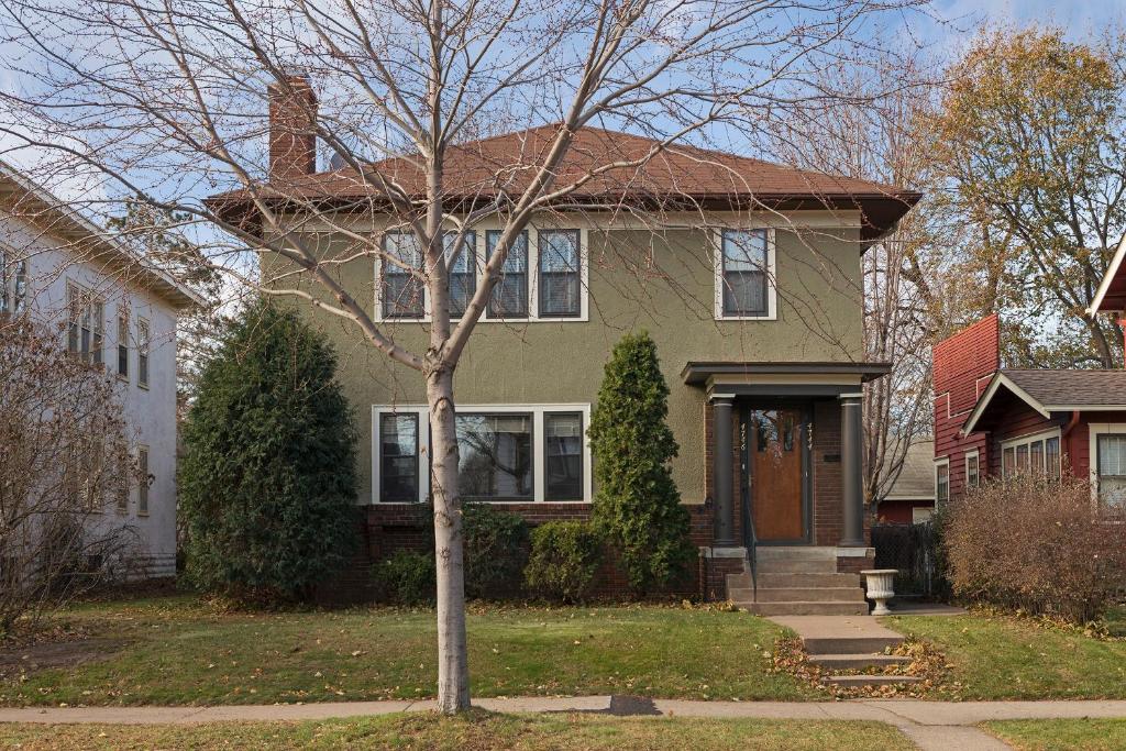 a house with a tree in front of it at Minneapolis - Blaisdell Avenue in Minneapolis