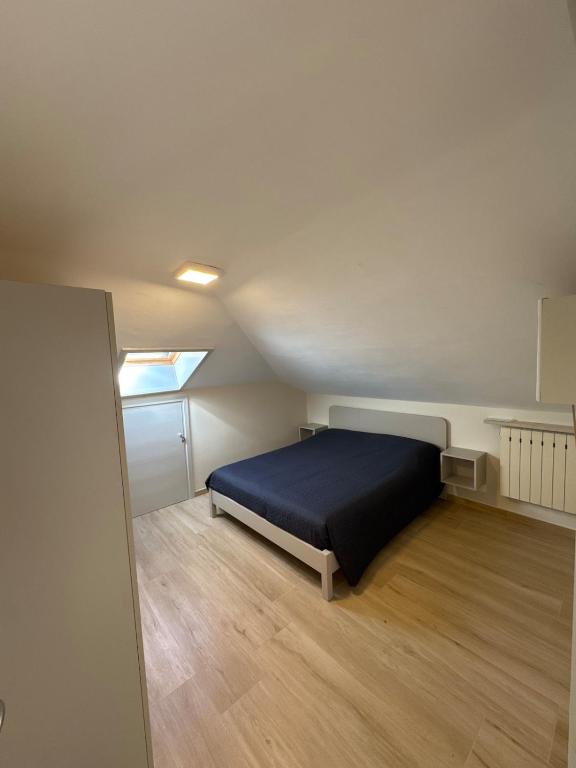 a bedroom with a bed in the middle of a room at La casa i due cedri in Cuneo