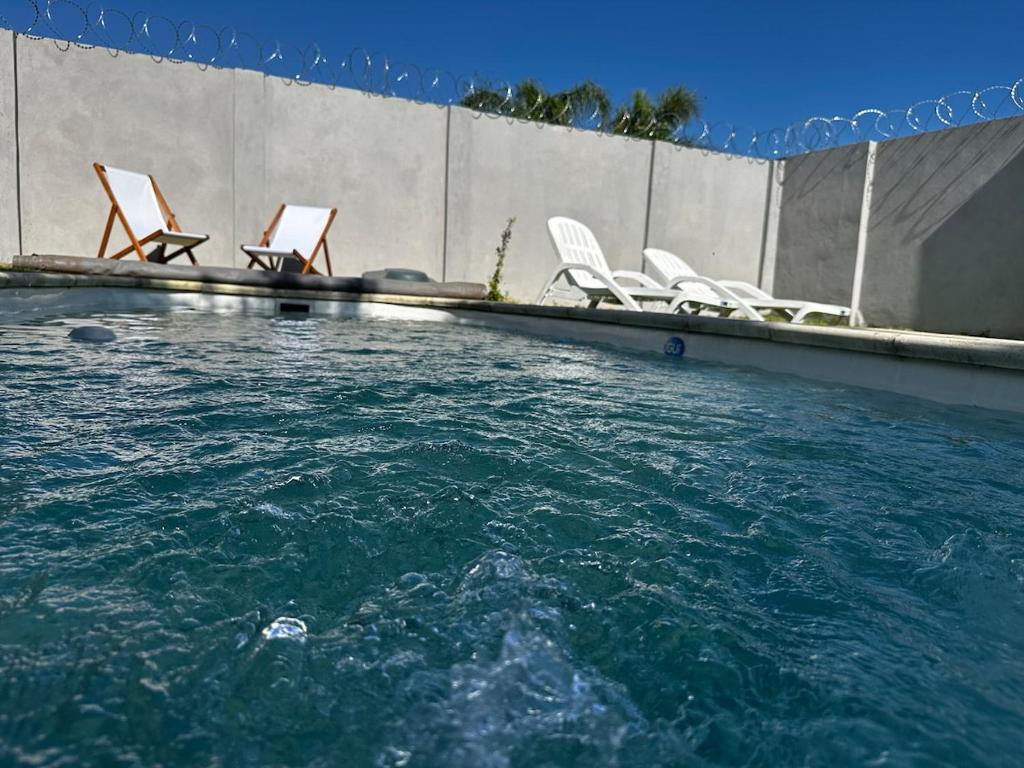 a group of chairs sitting in a swimming pool at La Luján Ayres de Campo in Luján