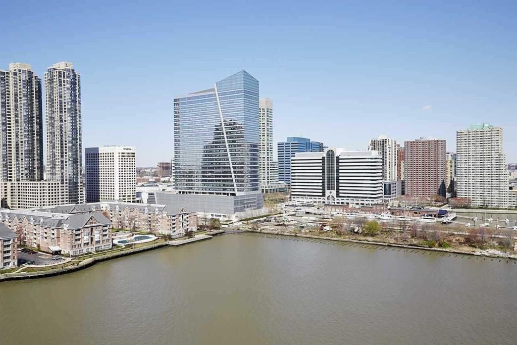 a view of a city with a river and buildings at Modern Stay in Downtown Jersey City, Close to NYC! in Jersey City