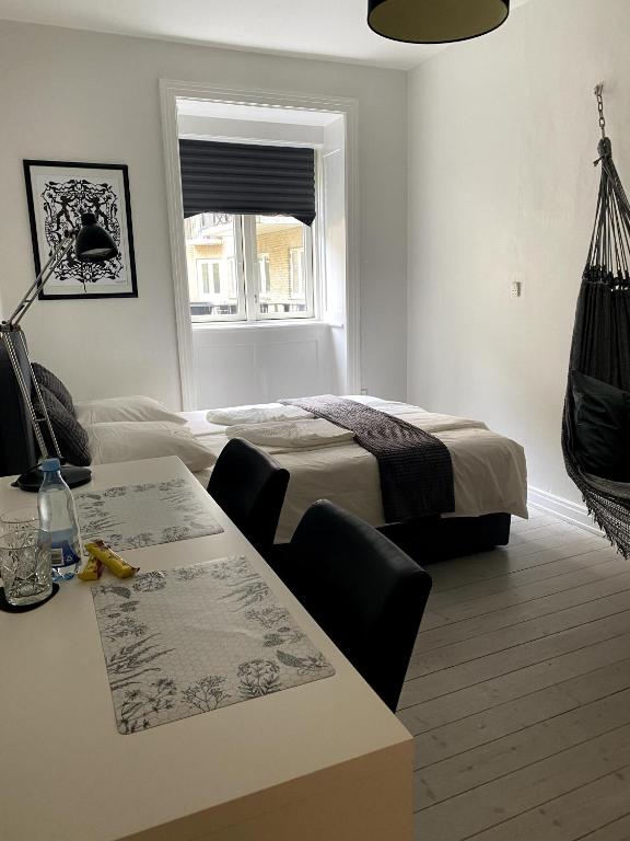 a bedroom with a bed and a desk and a table at Quiet room in lively area with helpful Host! in Copenhagen