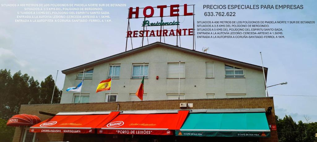 a hotel with flags on top of a building at Hotel Luso Leixoes- in Bergondo