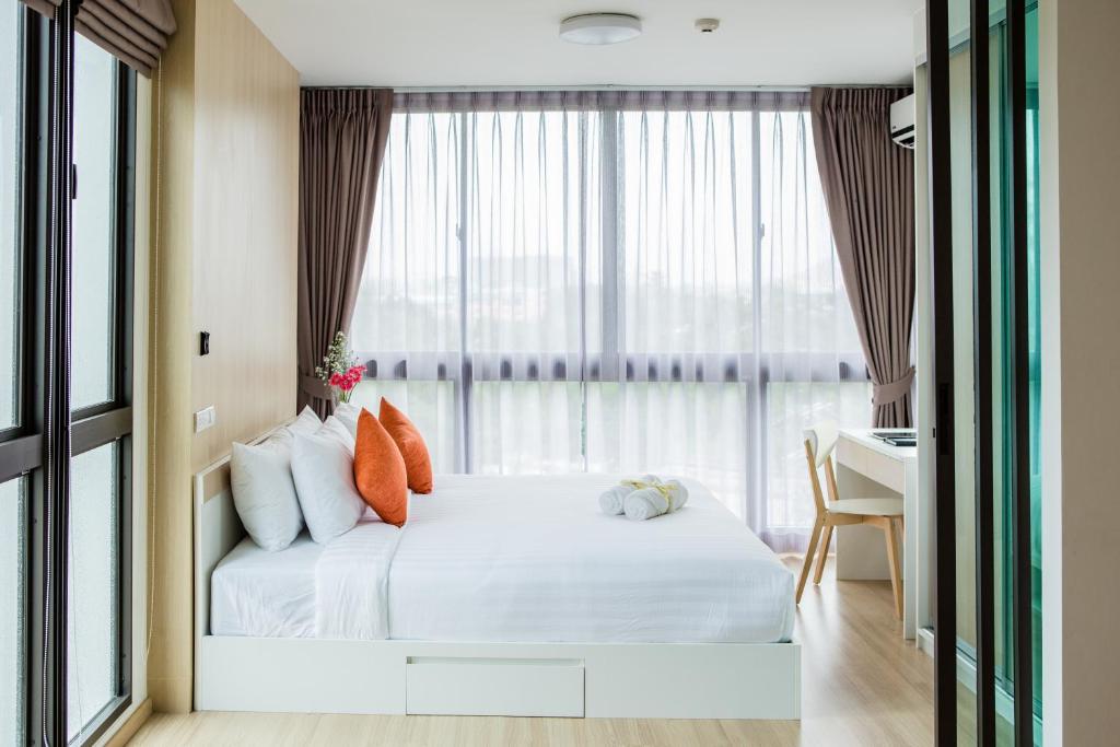 Un pat sau paturi într-o cameră la Connext Residence