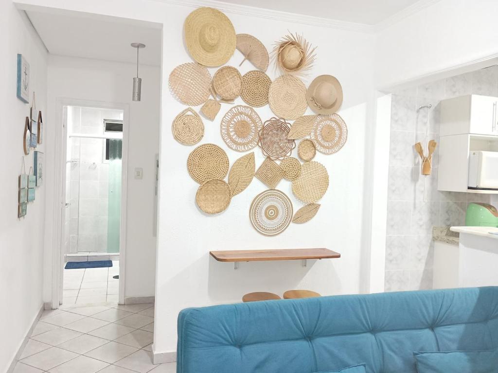サン・ビセンテにあるApartamento Horizonte Azulのリビングルーム(青いソファ、壁に帽子付)