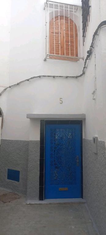 a blue door on the side of a building at DAR TAZROUT in Tangier