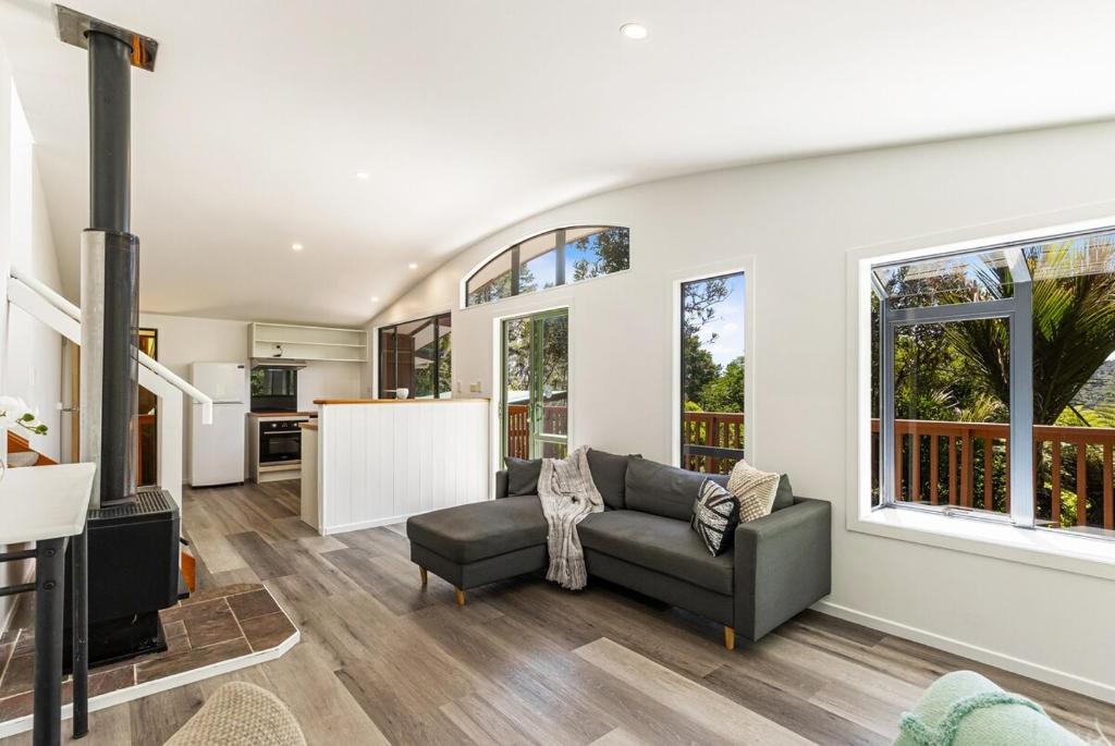 a living room with a couch and a table at Rainforest Retreat 2Bdr in Auckland