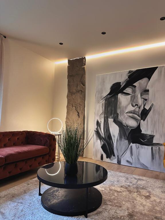 a living room with a couch and a table at Private Patio and Parking KING BED Elegant Retreat in Pittsburgh