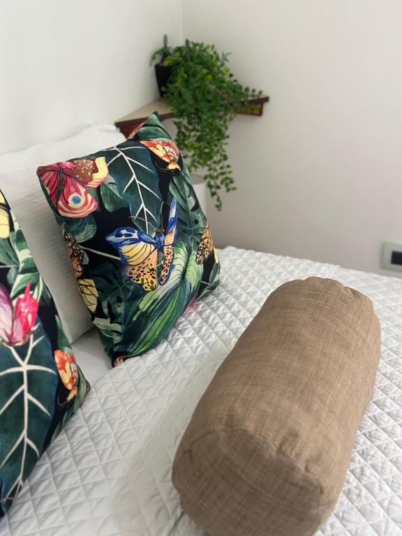 a bed with two pillows and a blanket on it at Hotel Boutique CasAguacate Apt Morfo close to Airport in Potrerillos