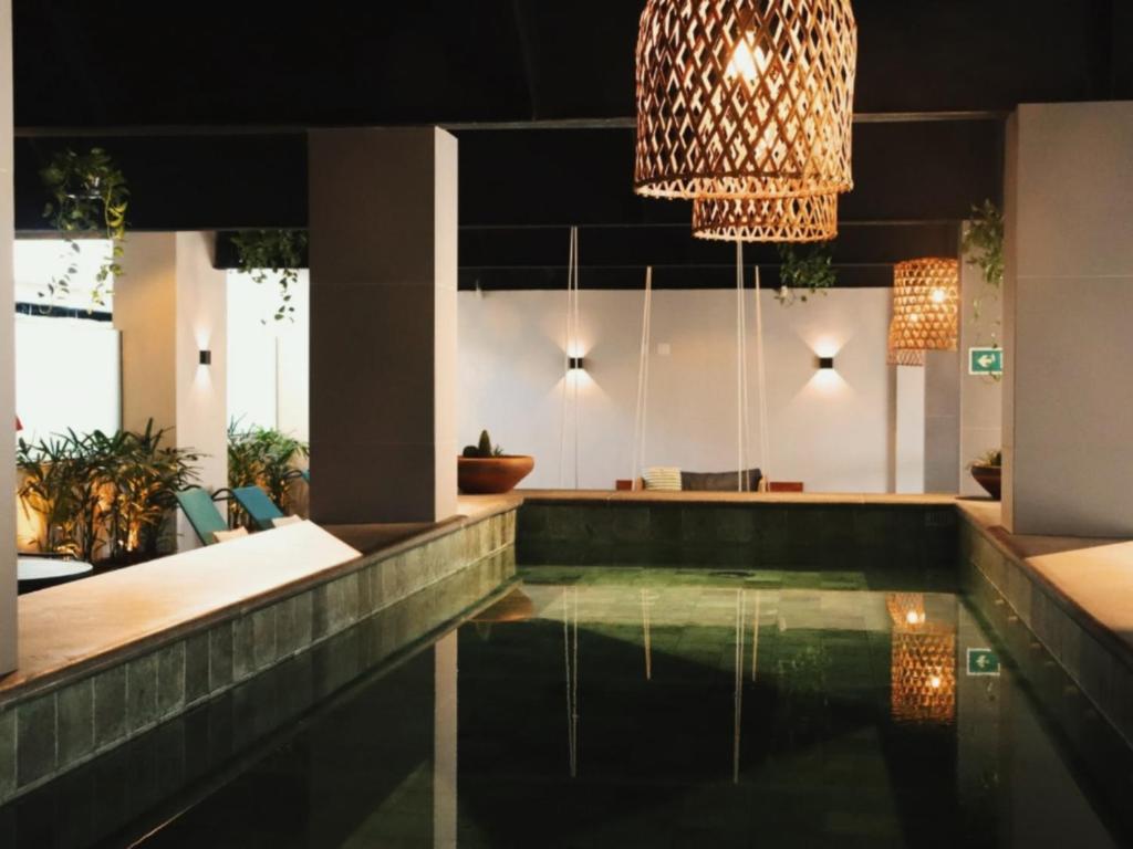 a house with a swimming pool and a chandelier at Kastel Petrópolis in Petrópolis