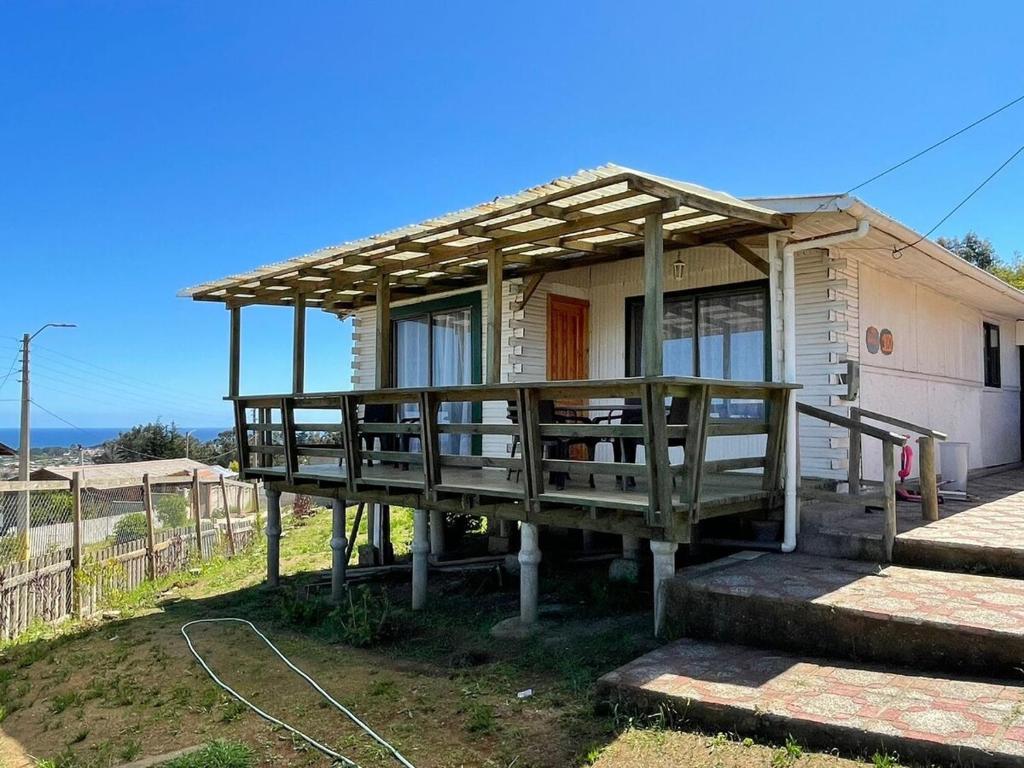 a small house with a roof on a porch at Casa Mirada Azul in Isla Negra