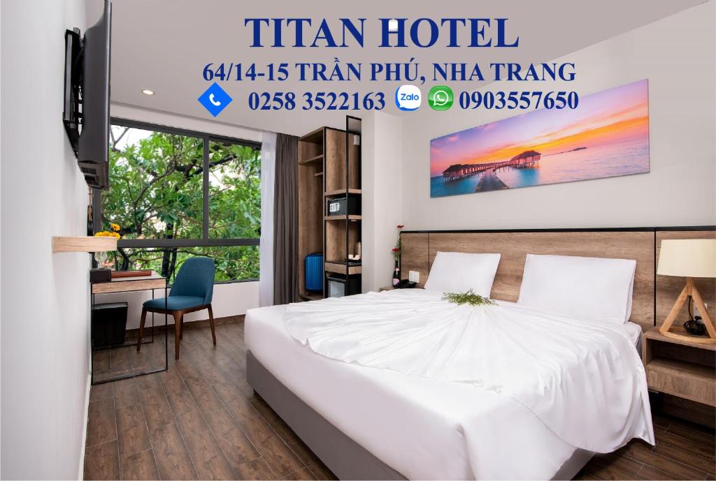 a hotel room with a bed and a desk at TITAN HOTEL - Formerly known as Golden Lotus Central Hotel in Nha Trang