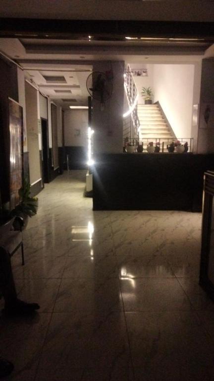 a lobby with a staircase in a building with lights at Host-Gram Hotel & Suites Downtown in Cairo