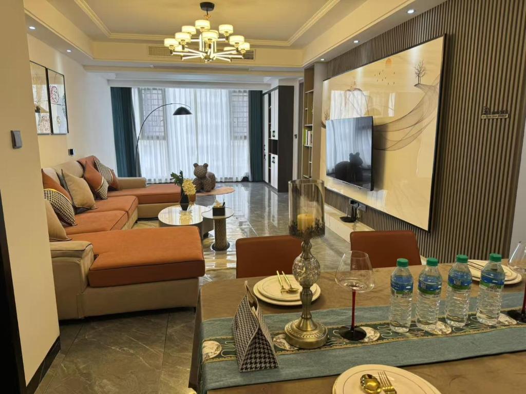 a living room with a couch and a table at Xiaowo SmileNest Downtown Scenic Spot Ticket Service Close to Tianmen Mountain Scenic Area Ideal for Couples, Families and Group Bookings in Zhangjiajie