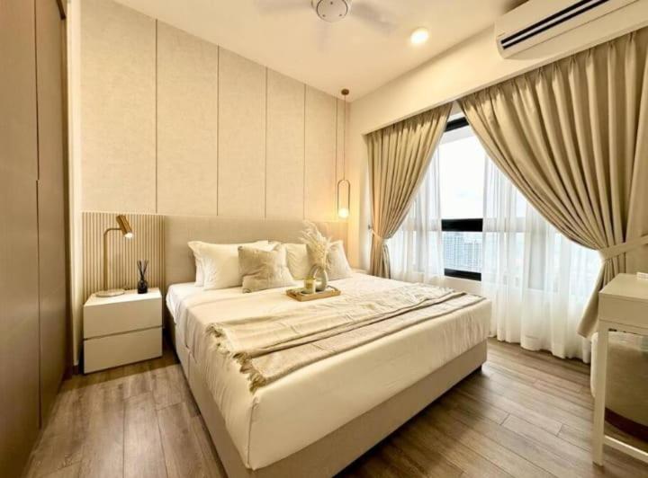 a bedroom with a large white bed and a window at Agile universal service residence TRX KL in Kuala Lumpur
