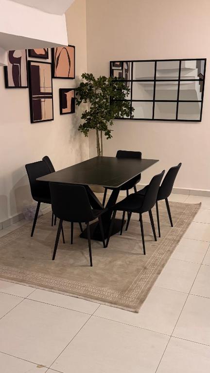 a black dining table and chairs in a room at CrystalsLodge in Ibeju