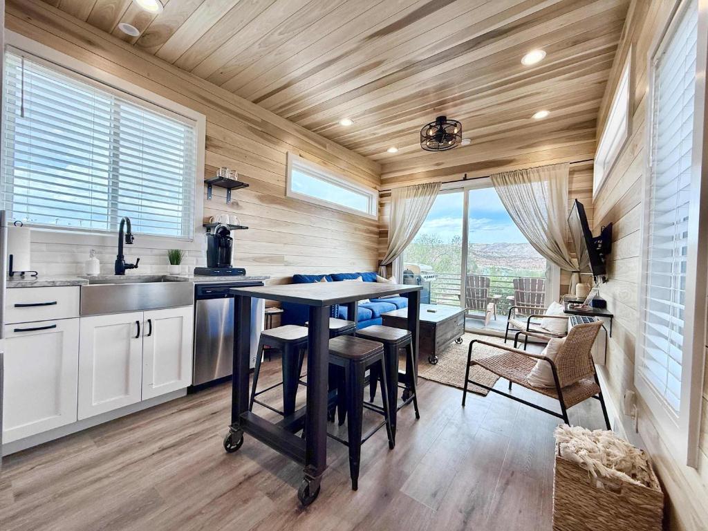 a kitchen with a table and chairs in a room at Escalante Escapes Prickly Pear- Bunk Escape in Escalante