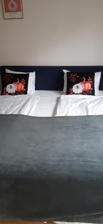 a bed with two pillows on top of it at Wonderful Stay Helsingborg in Helsingborg