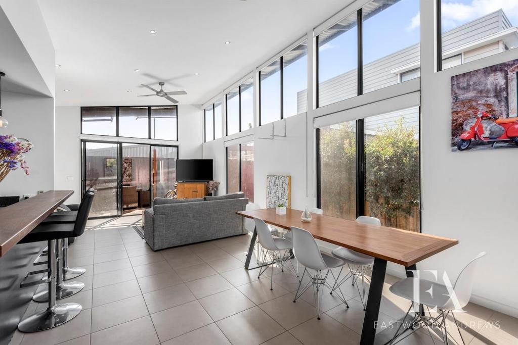 a dining room with a table and some chairs at Pet Friendly, Flex Check-InOut, Australiana Touch in Geelong West