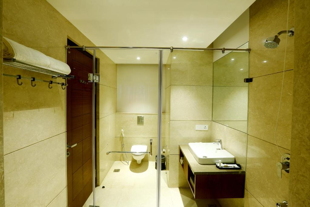 a bathroom with a toilet and a sink and a shower at SK Park Blu in Sonīpat