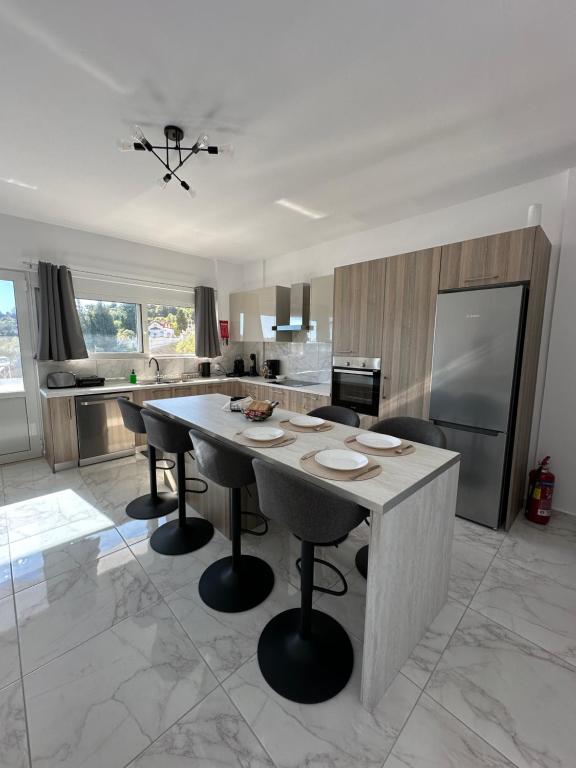 a large kitchen with a large table and chairs at Casa Platania in Eleoúsa