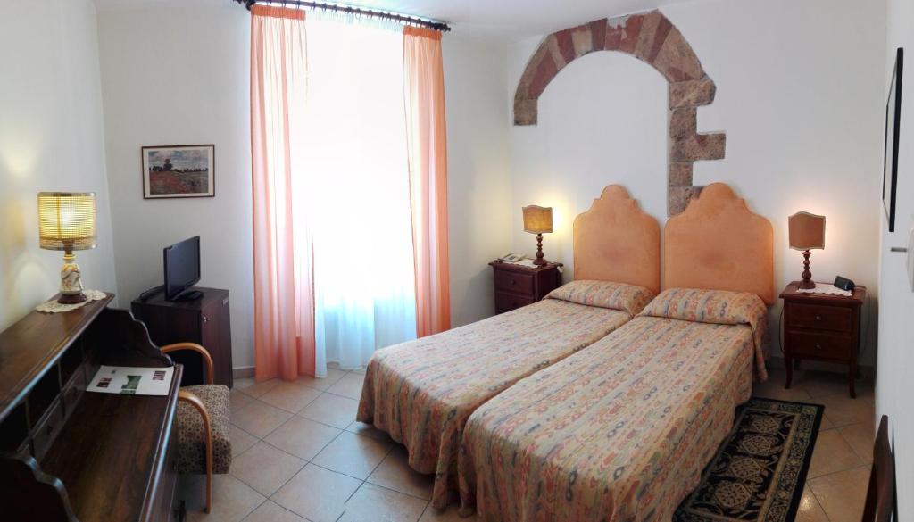 Postel nebo postele na pokoji v ubytování Hotel Umbra