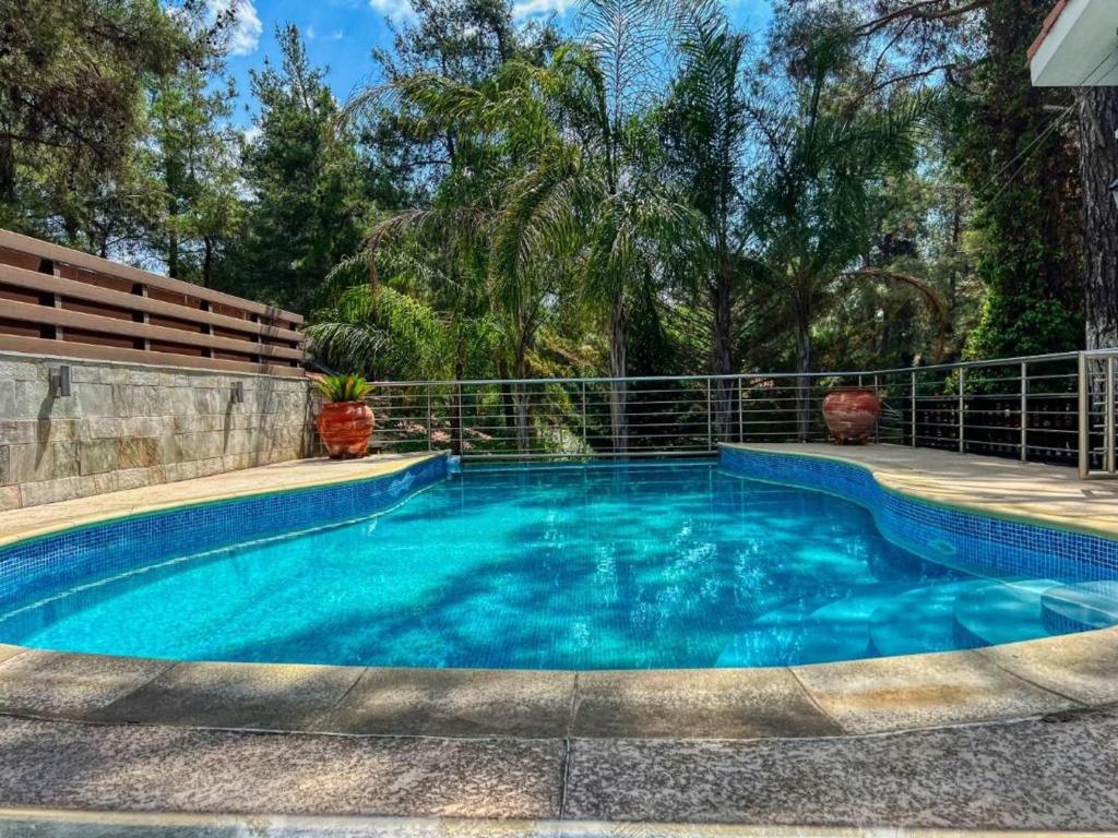 a swimming pool with a fence around it at Charming Villa in Moniatis, Cyprus - Private Pool Garden in Saittas