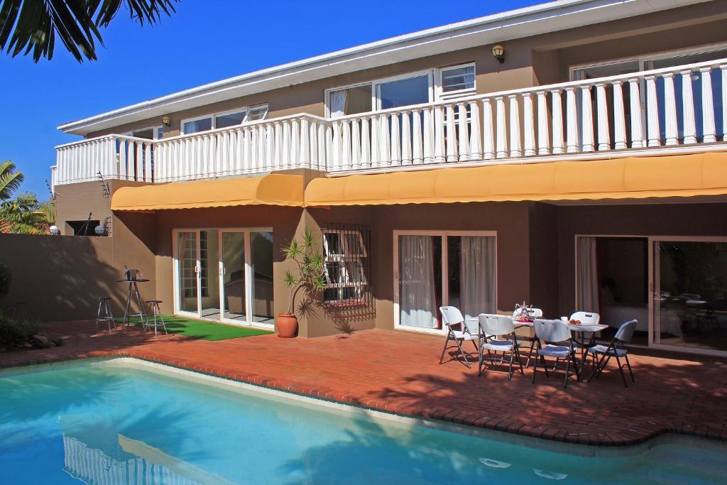 a house with a pool and a table and chairs at Durban Manor Guest House in Durban