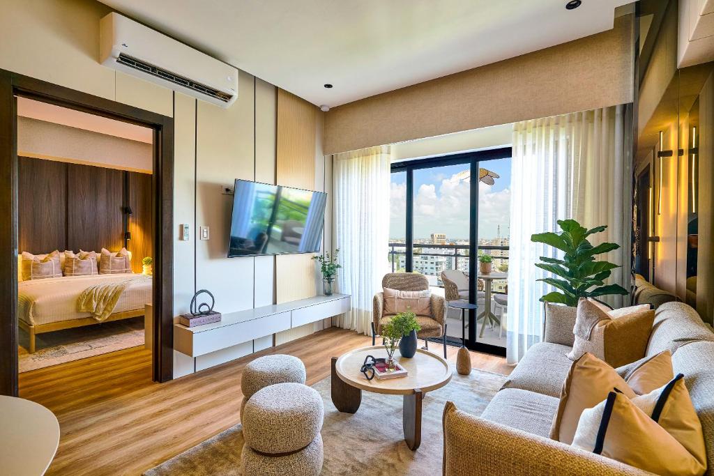 a living room with a couch and a bed at ® {The~City~LUX~Place}@DowtownSD in La Julia