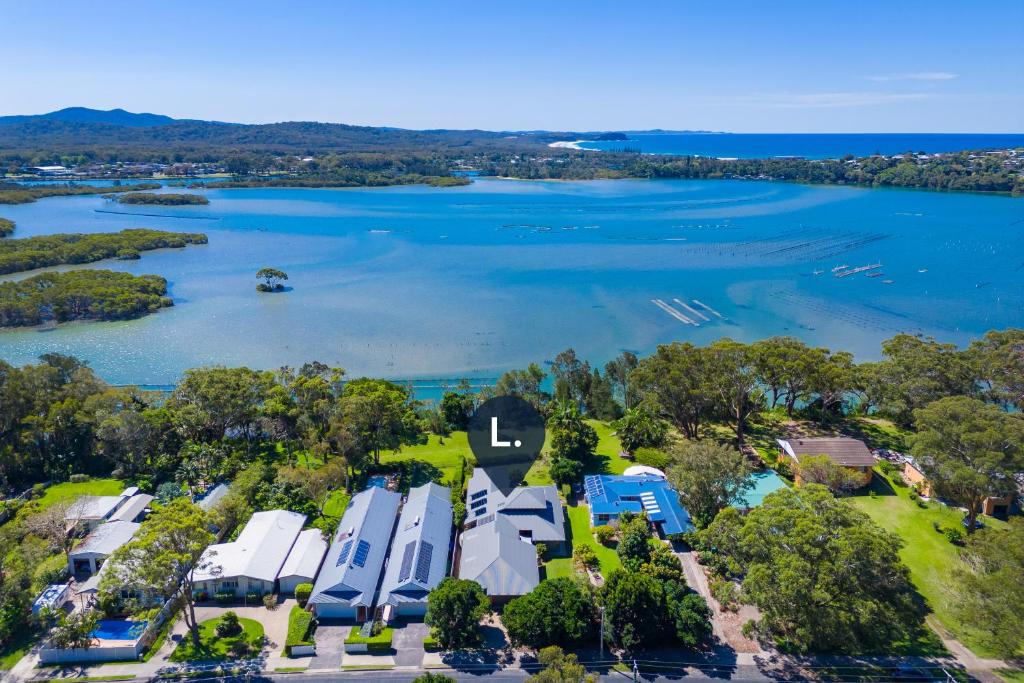 an aerial view of a lake with a group of rvs at Lakeside Bliss in Dunbogan