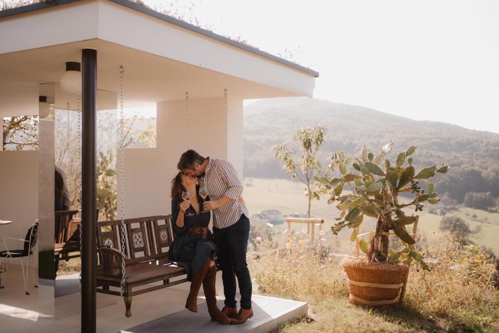 a man and a woman with a dog in front of a house at Boutique-Hotel maison 41 - Adults Only in Bad Gleichenberg