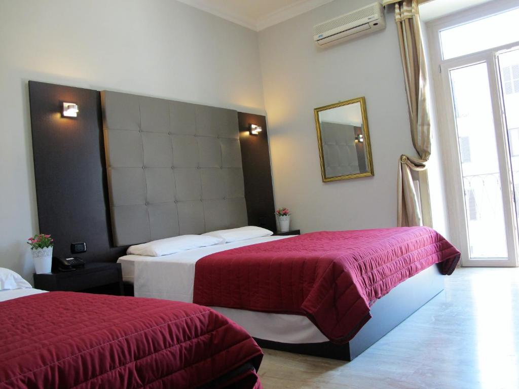 Hotel d'Este tesisinde bir odada yatak veya yataklar