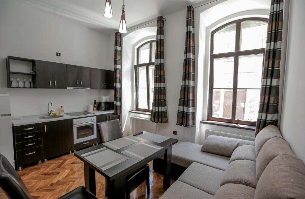 a living room with a couch and a table at Poarta Schei Residence in Braşov