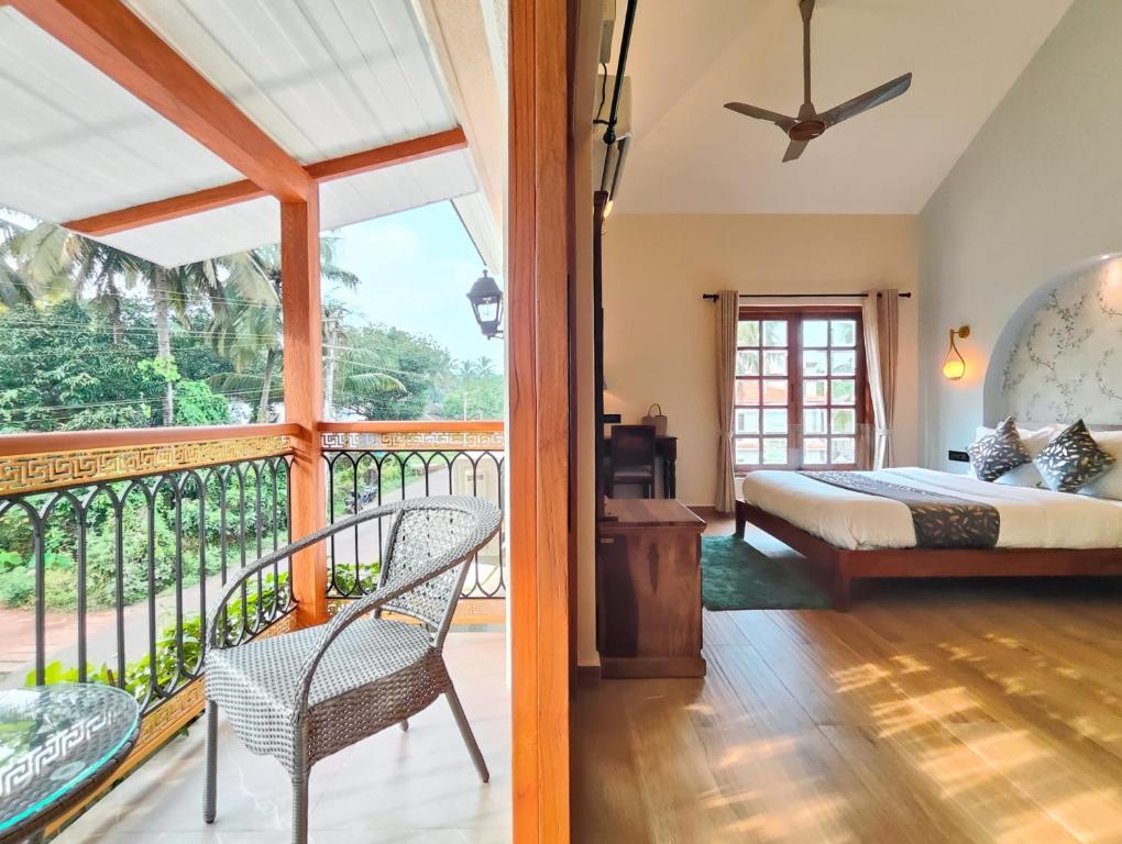 a bedroom with a bed and a balcony at Villa Laz, Parra close to calangute- Pool,Jacuzzi,Cook in Parra