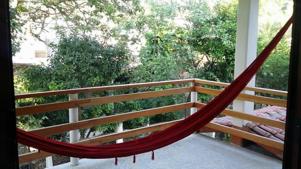 a hammock on the balcony of a house at Casa Ziga Centro in Mazunte