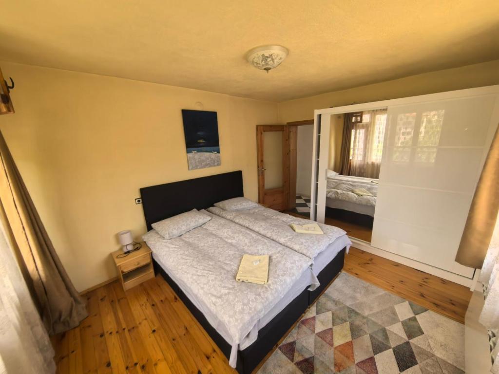 a bedroom with a large bed in a room at Къща Томови,стаи за гости in Devin