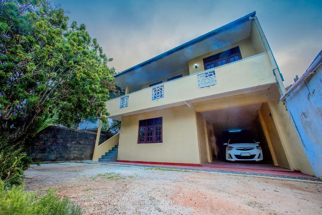 a car parked in the garage of a house at Villa Enchanté - Apartment in Nugegoda 2BR in Talapatpitiya