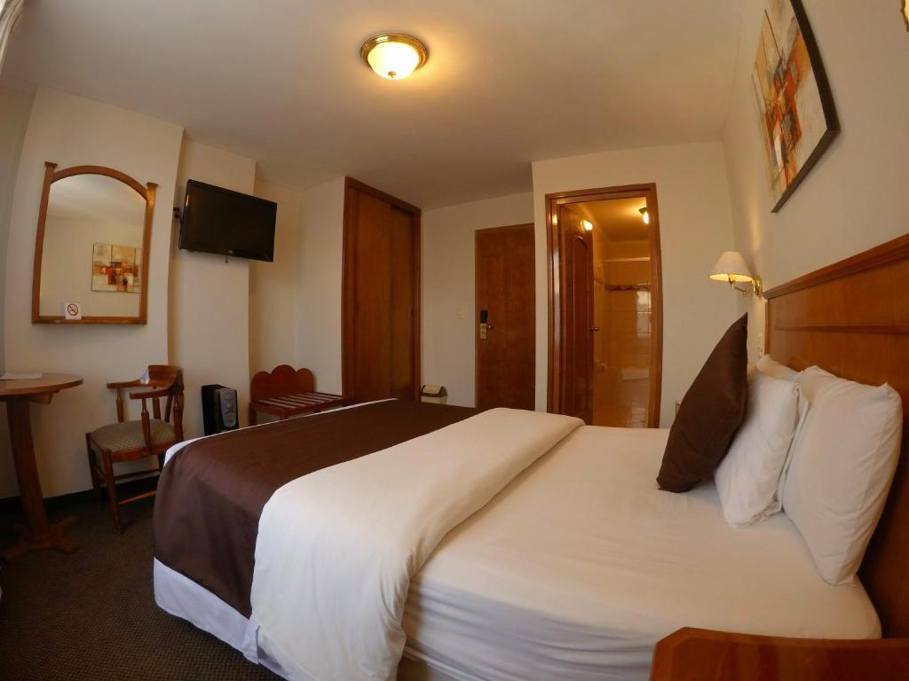 Cama o camas de una habitación en Casona Plaza Hotel Puno