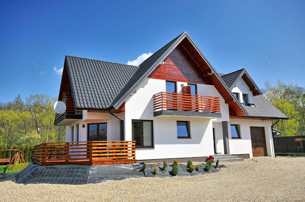 a white house with a black roof at Willa Kamilówka in Rabka