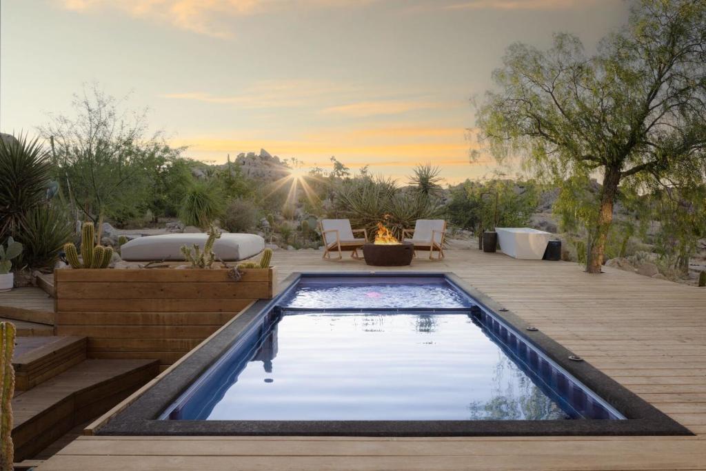 a backyard with a swimming pool and a fire pit at Boulder Horizons - PoolSpaCold Plunge on 5 acres in Yucca Valley