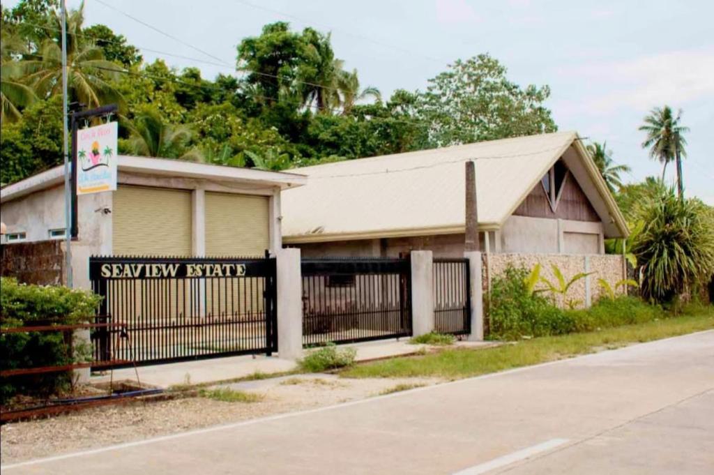 a house with a gate and a sign that says subway repair at Sea Esta Cruz Siargao in General Luna