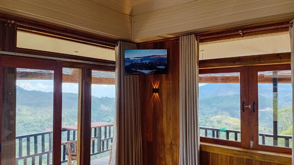a room with windows and a television on the wall at Windyhill Shalley in Demodera