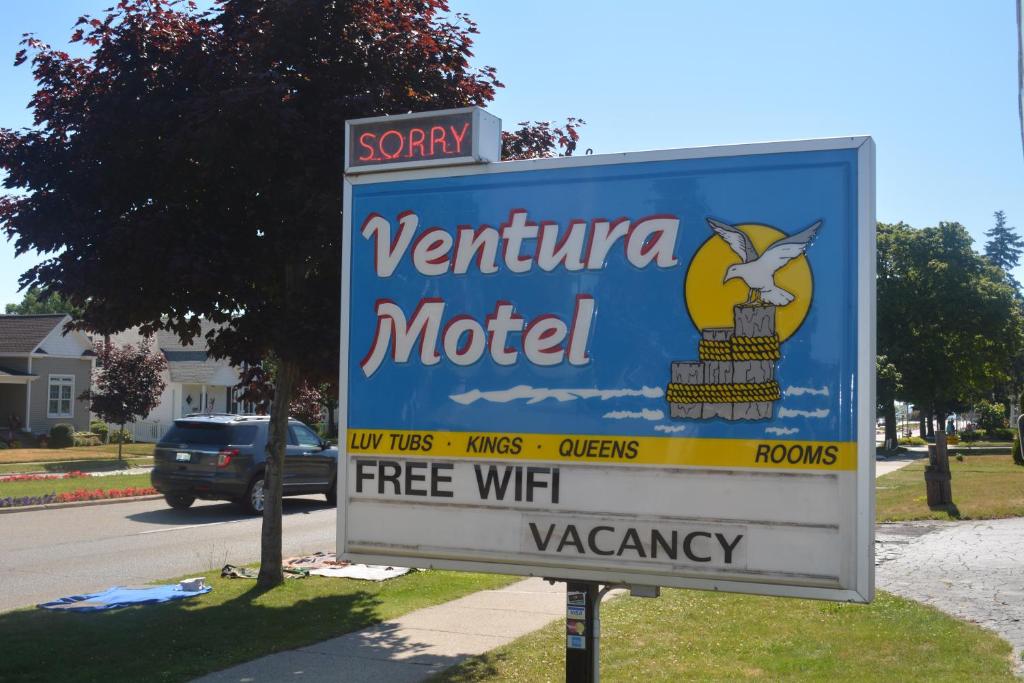 a sign for a verizon motel on a street at Ventura Motel in Ludington