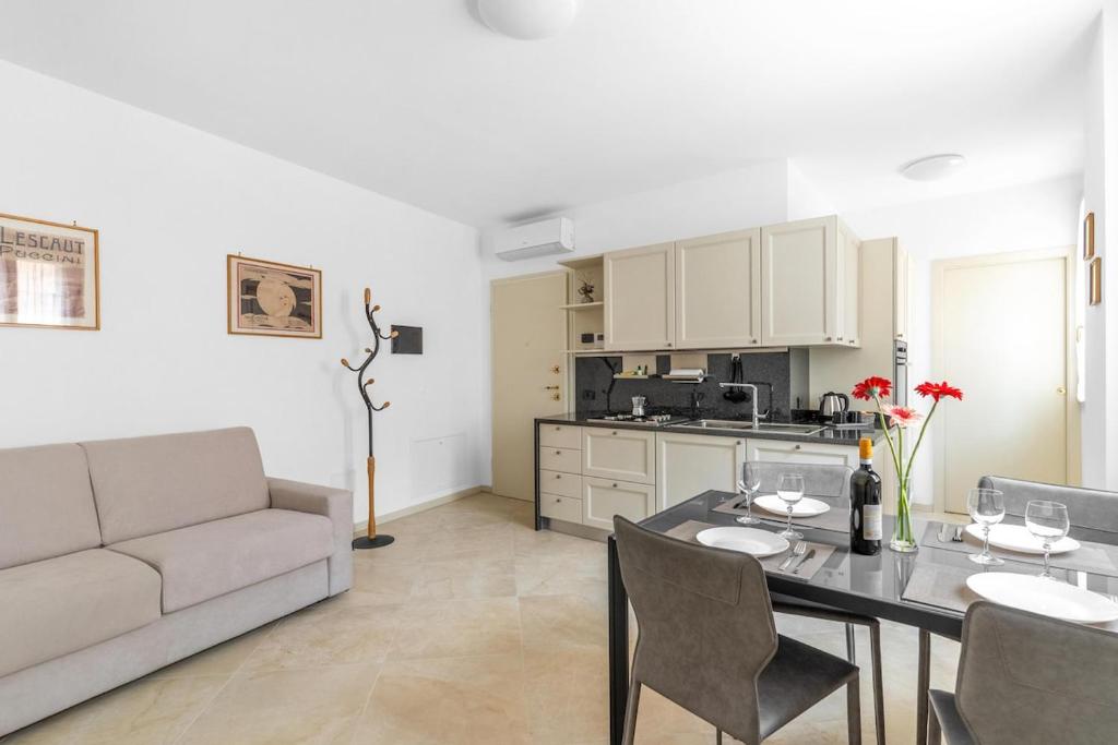 a living room with a table and a couch at Casa della Regina, near Lake Garda in Montichiari